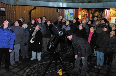Members of the public enjoy their first views of Saturn through a telescope